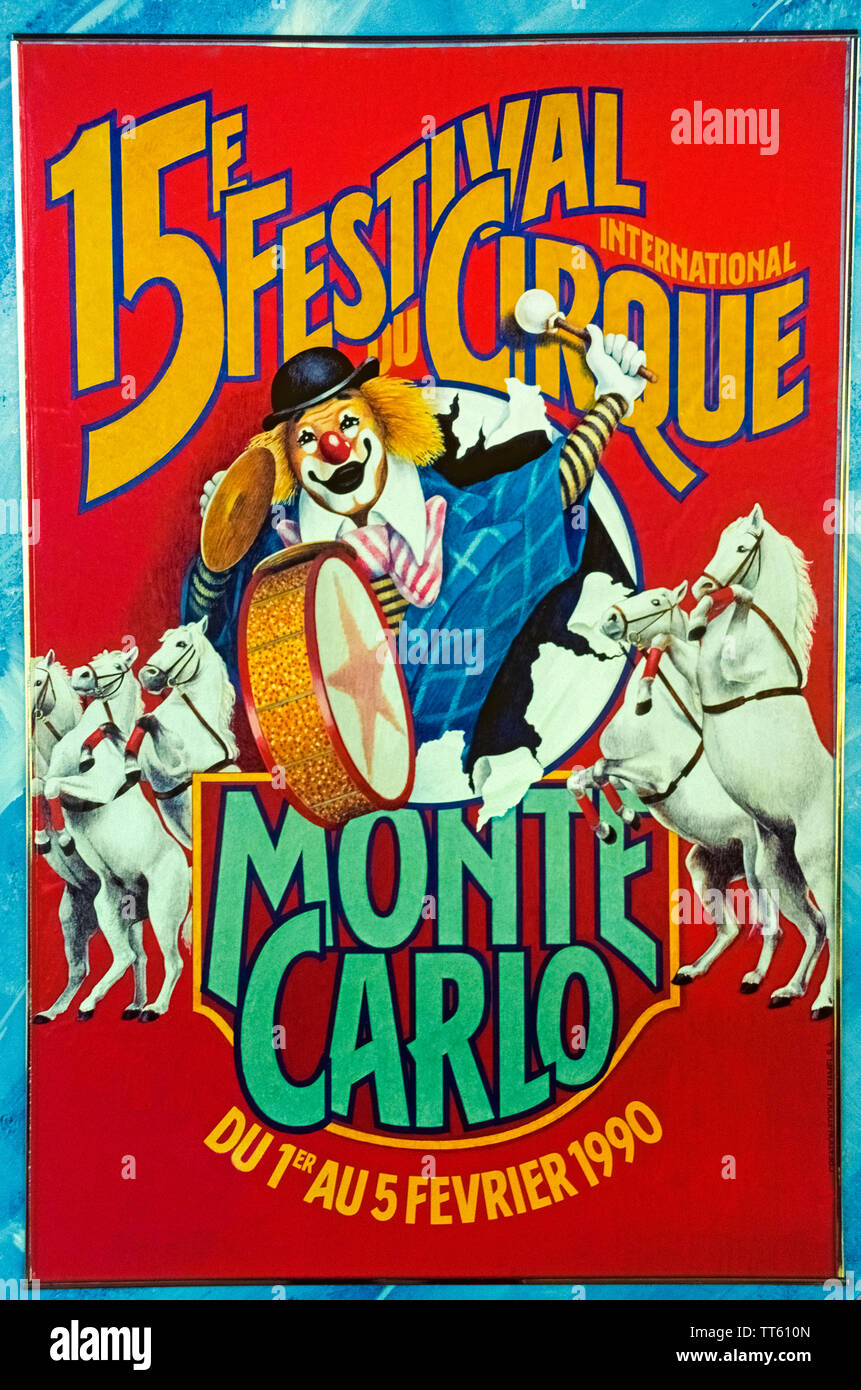 A bright red poster featuring performing horses and a clown advertises the 15th annual International Circus Festival of Monte Carlo that was held in 1990 in the Principality of Monaco on the French Riviera in Europe. The renowned festival was created in 1974 by the late Prince Rainier III who had a lifelong passion for the circus and wanted to showcase and honor its top performers from around the world. The event continues to the present day and every January presents 25 of the best circus acts in the business. Stock Photo