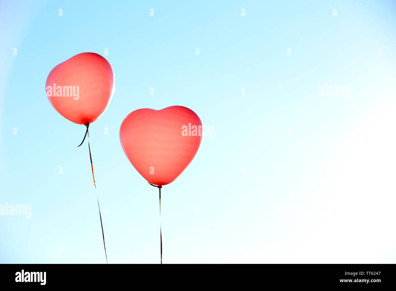Love heart balloons on sky background Stock Photo - Alamy