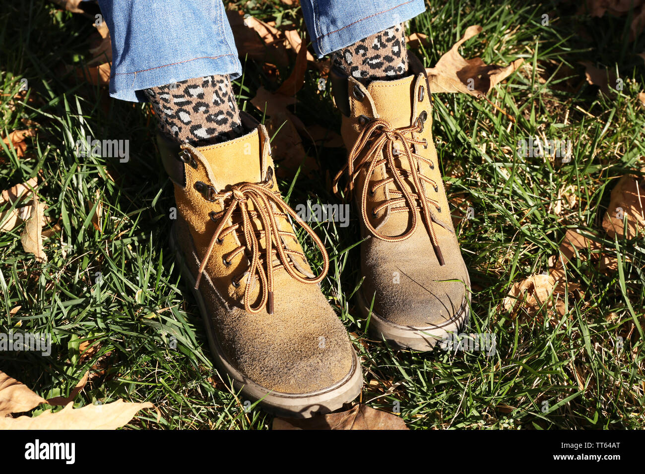 Foot In Boot Feet in boots on grass background Stock Photo - Alamy