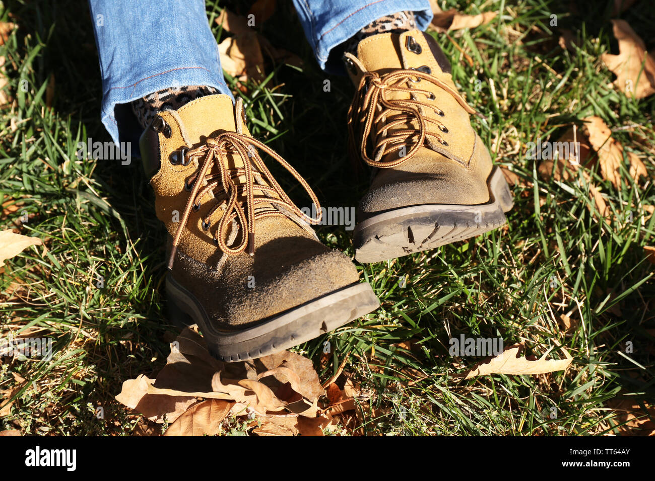 Feet in boots on grass background Stock Photo Alamy