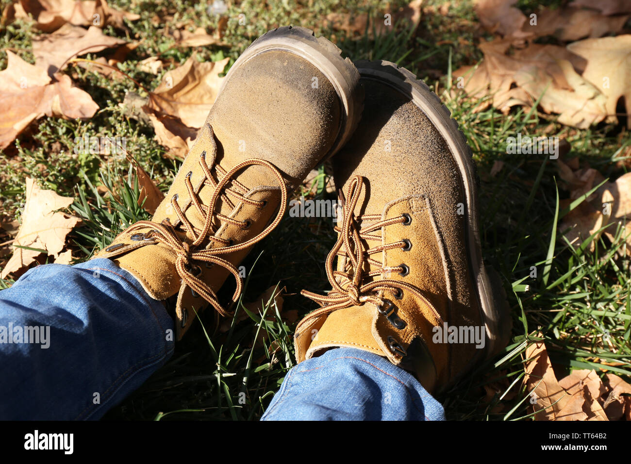 Foot In Boot Feet in boots on grass background Stock Photo - Alamy