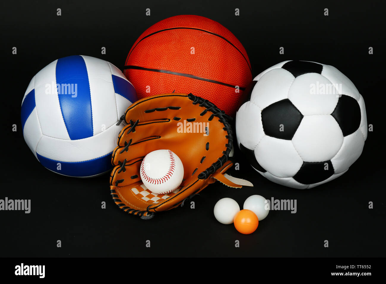 Sports balls on black background Stock Photo - Alamy