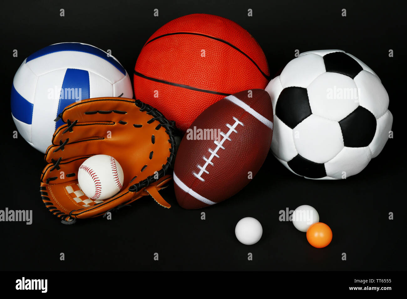 Sports balls on black background Stock Photo - Alamy