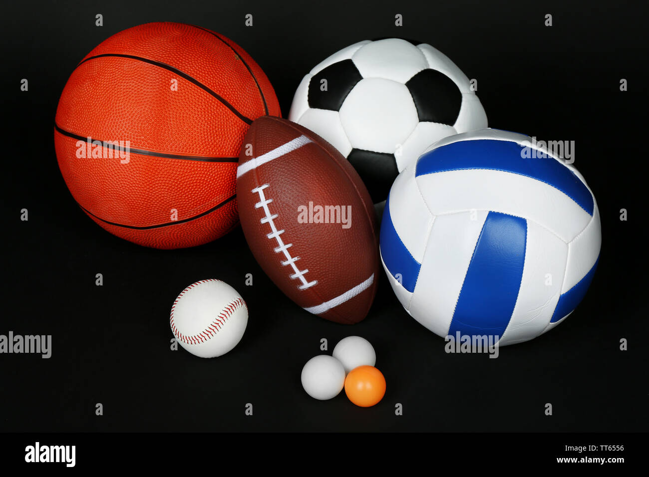 Sports balls on black background Stock Photo - Alamy