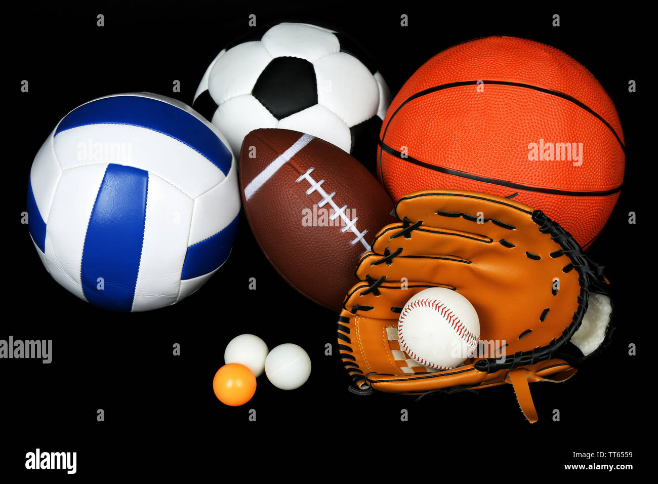 Sports balls on black background Stock Photo - Alamy