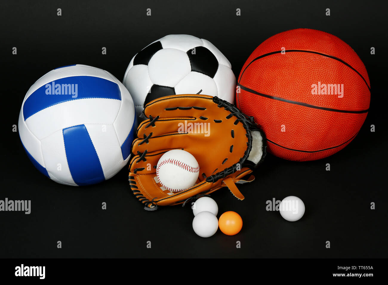 Sports balls on black background Stock Photo - Alamy