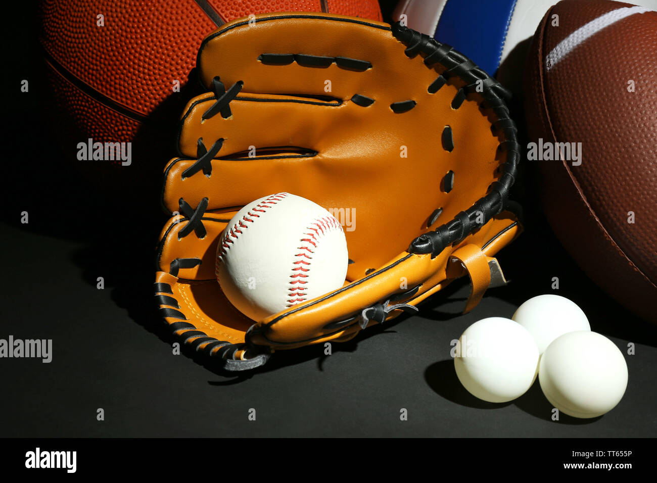 Sports balls on black background Stock Photo - Alamy