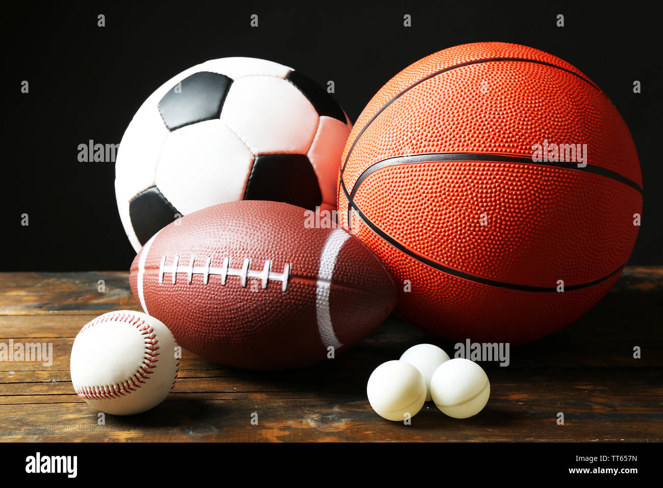 Sports balls on black background Stock Photo - Alamy