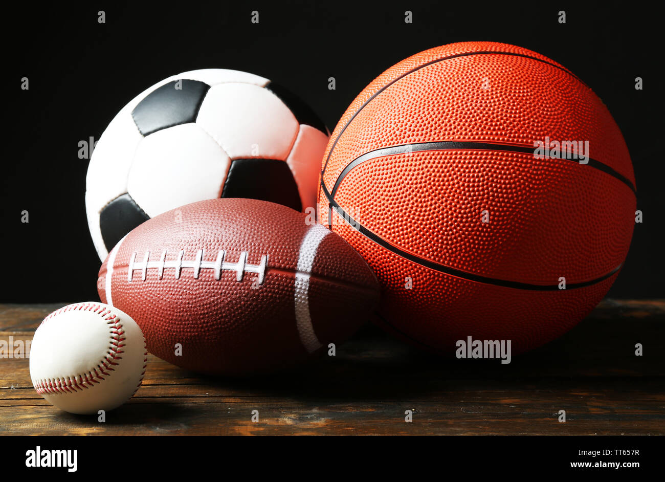 Sports balls on black background Stock Photo - Alamy