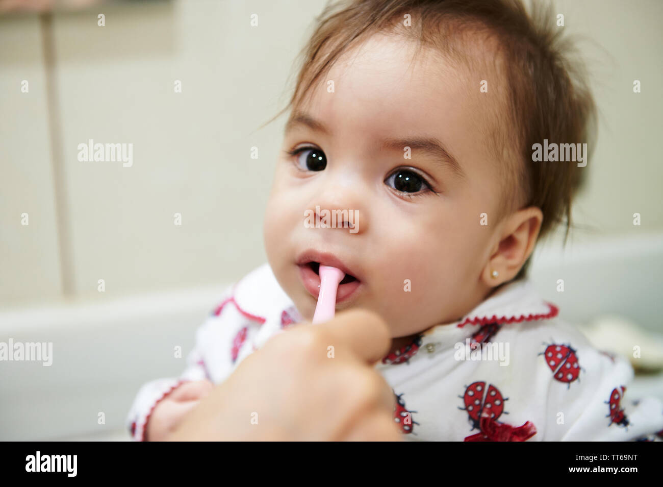 Baby brushing teeth before go sleep. Portrait of little kid with toothbrush Stock Photo