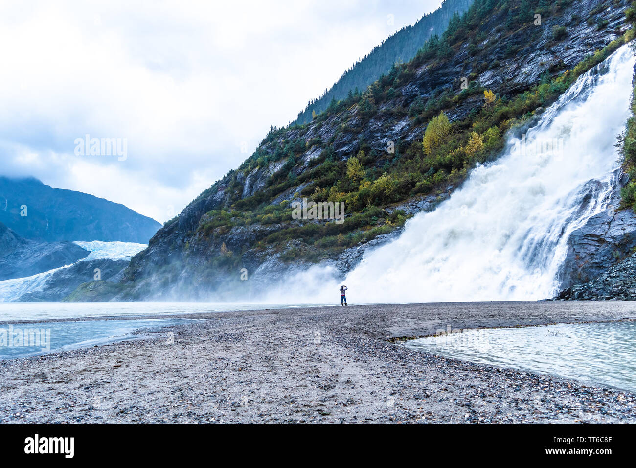 Nugget Falls, also known as Nugget Creek Falls or Mendenhall Glacier Falls, a waterfall downstream of the Nugget Glacier flowing into Mendenhall Lake. Stock Photo