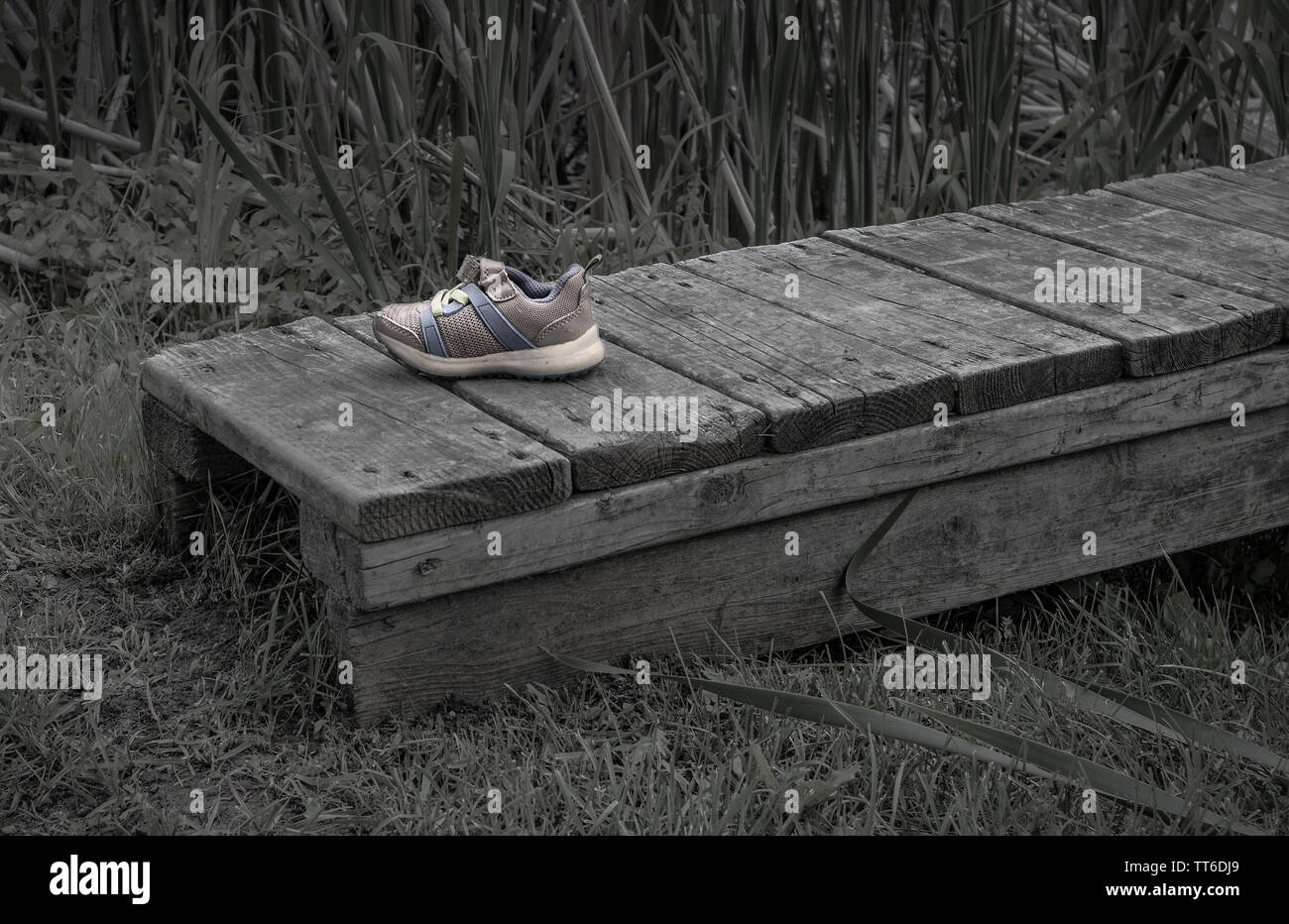 On a small dock, the shoe of a child..all alone ..Monochrome Stock Photo