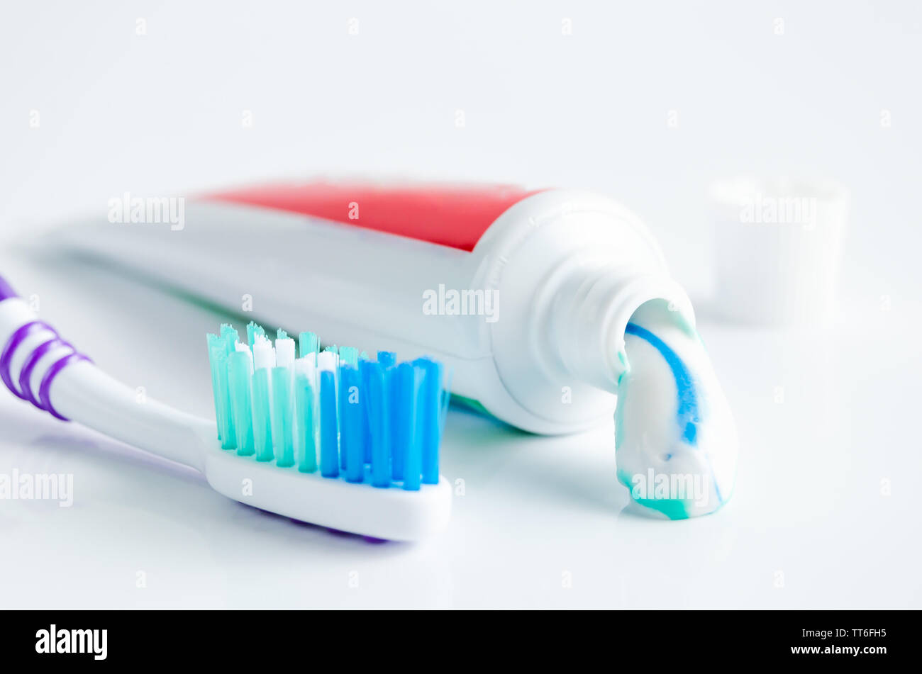 A tube of toothpaste and a toothbrush on white background closeup Stock ...