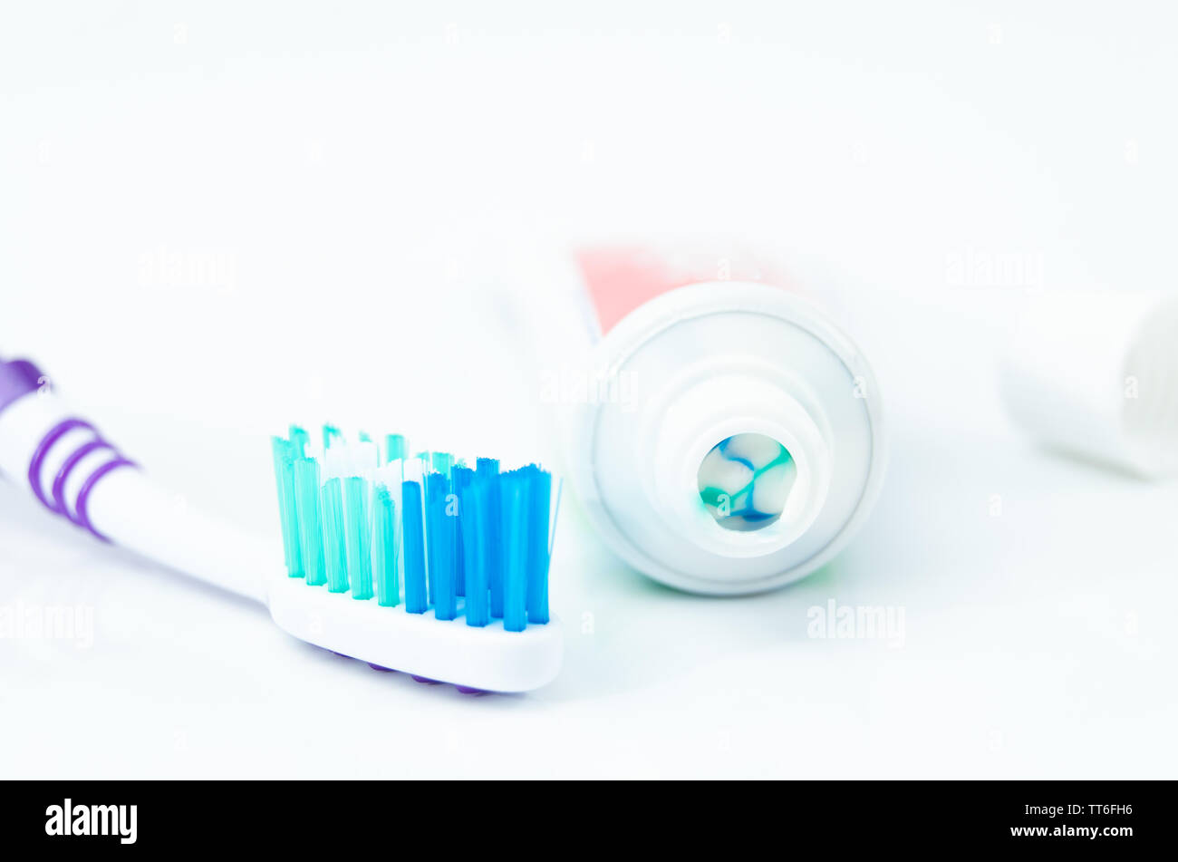 A tube of toothpaste and a toothbrush on white background closeup Stock ...