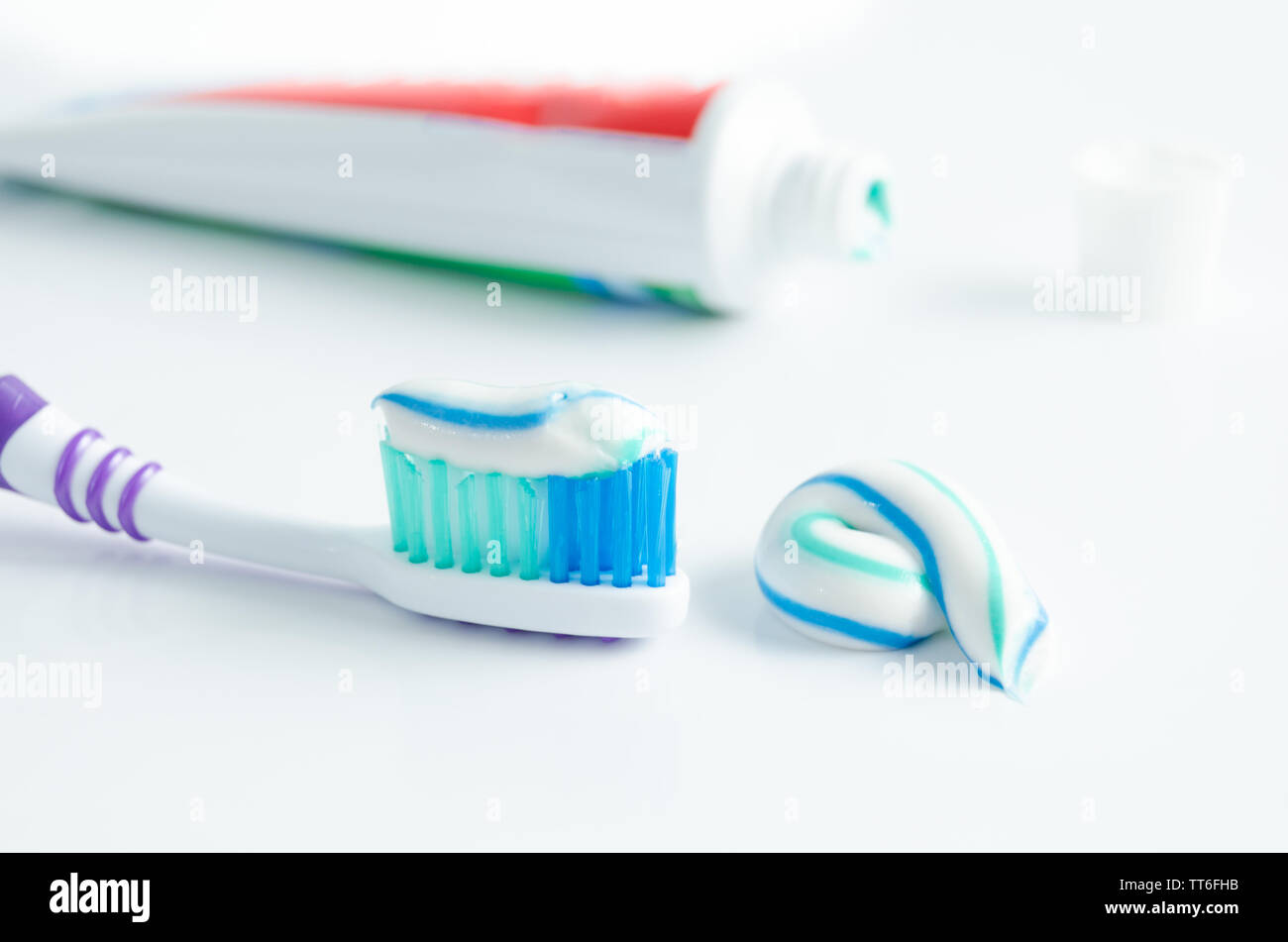 A tube of toothpaste and a toothbrush on white background closeup Stock ...