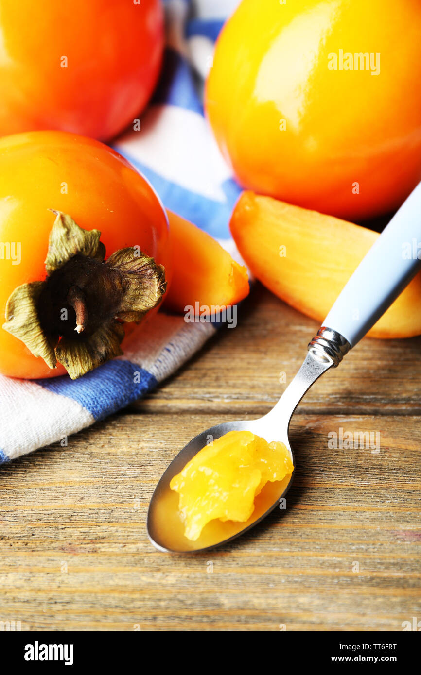Ripe persimmons on wooden background Stock Photo - Alamy