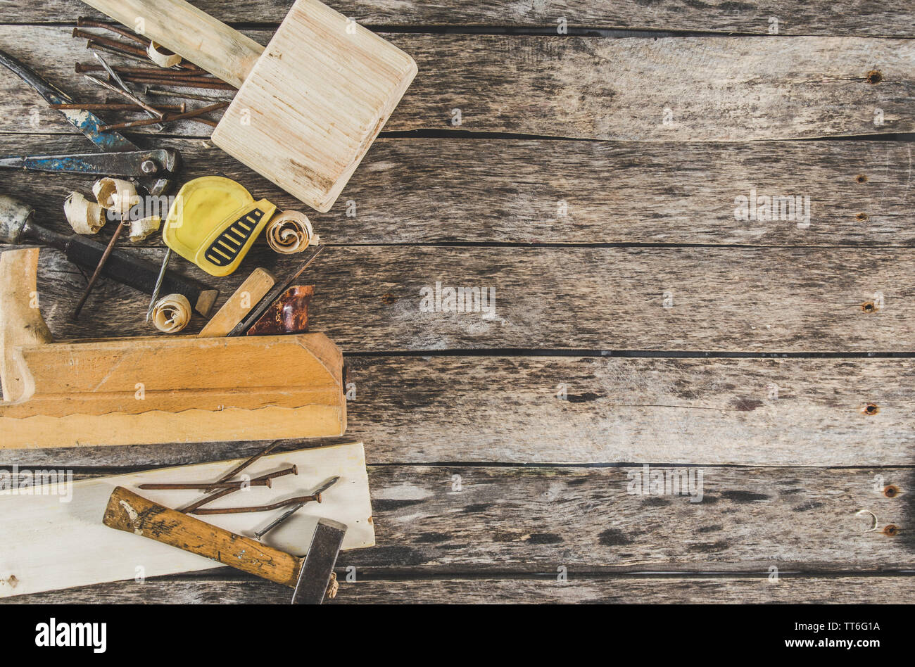 The carpenter tools on wooden bench, plane, chisel,mallet, tape, hammer ...