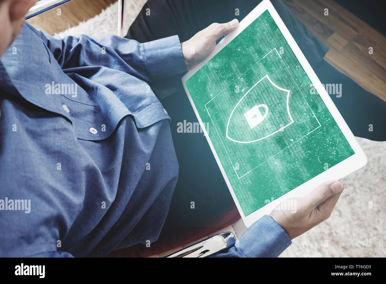 Digital data security system, and internet safety. a man using digital tablet and shielding lock icon on screen Stock Photo