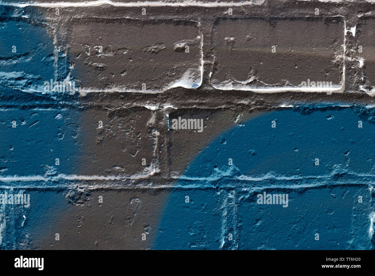 Brick wall painted in different colors close up. Abstract background Stock Photo