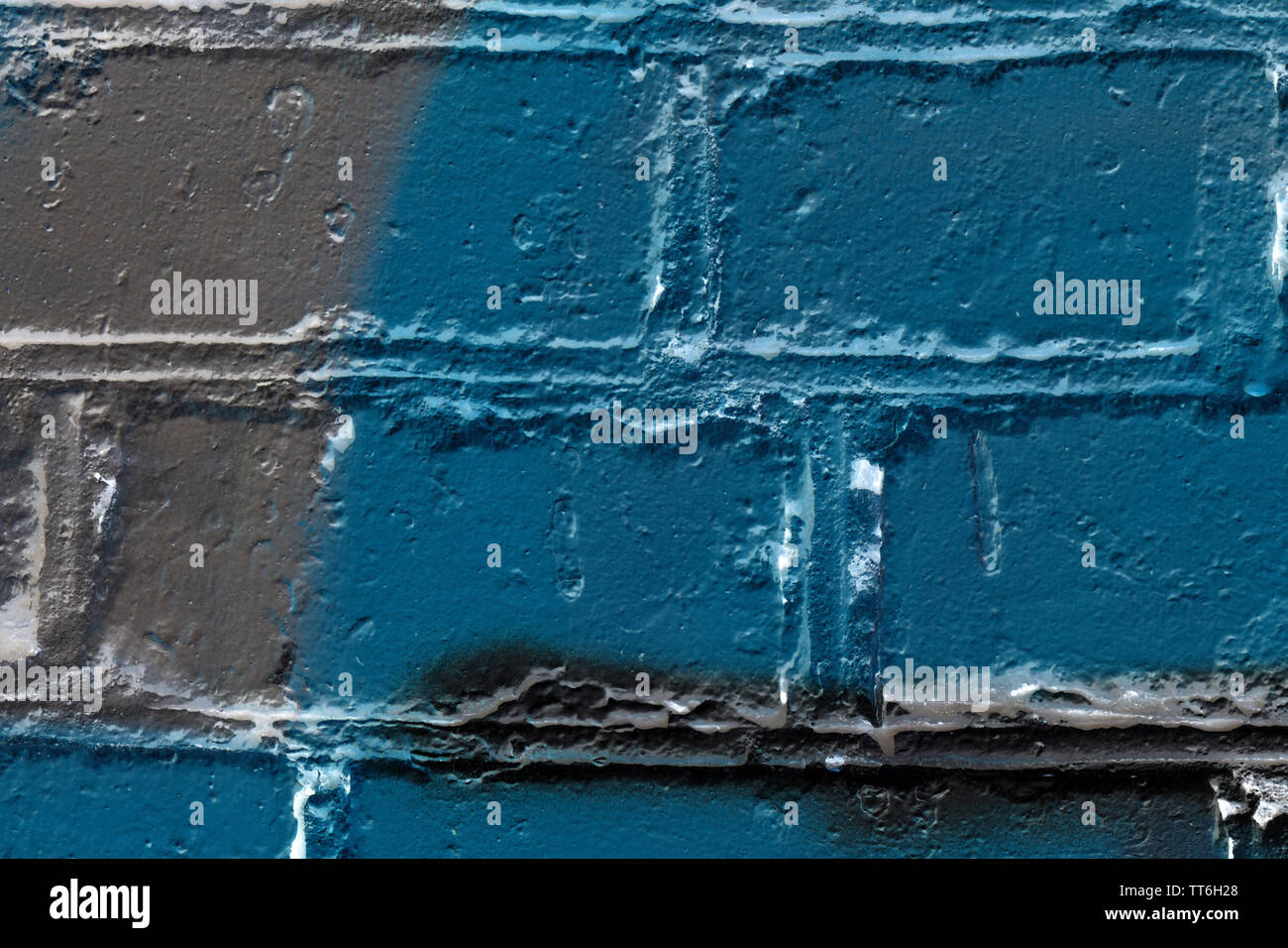Brick wall painted in different colors close up. Abstract background Stock Photo