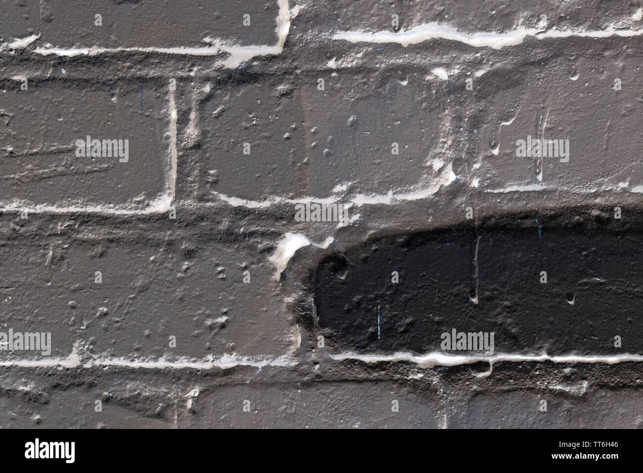 Brick wall painted in different colors close up. Abstract background Stock Photo
