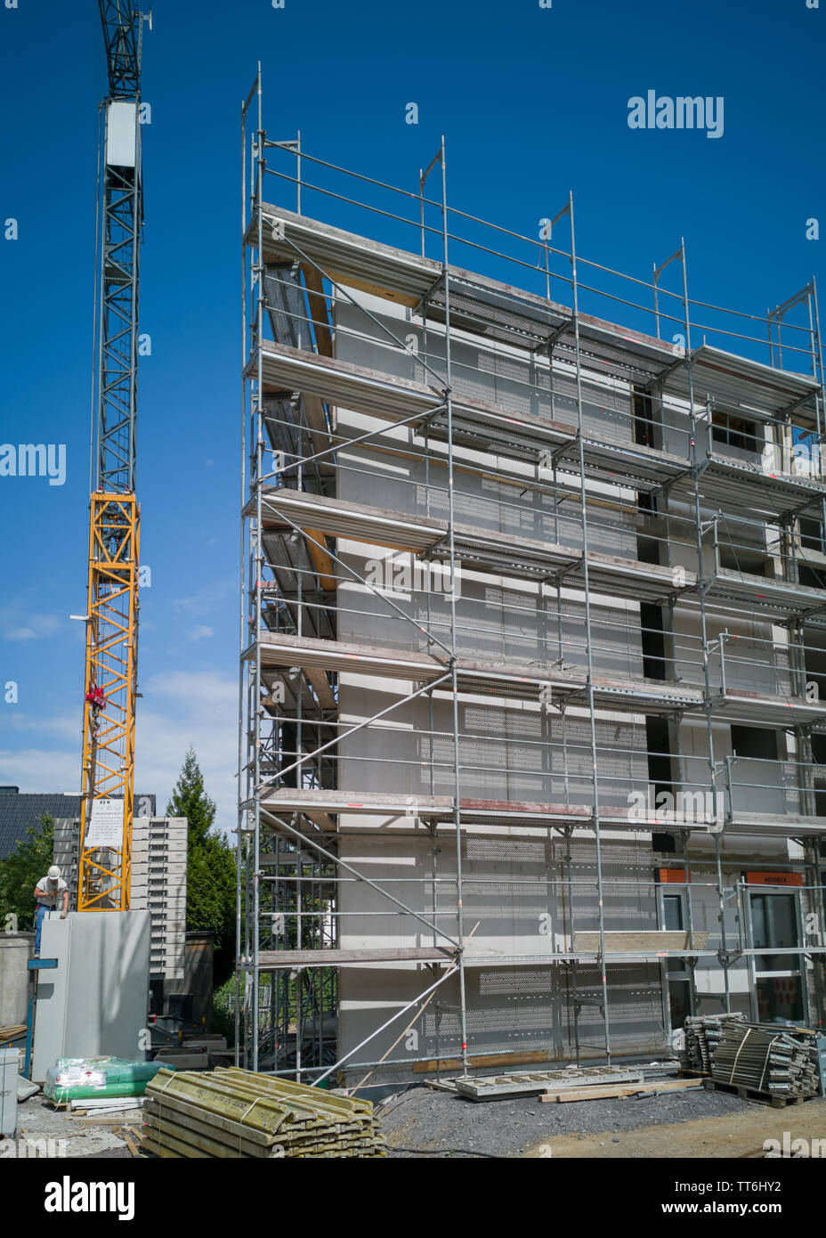 Neuwied, Germany - June 14, 2019: construction site for a new  multistoried building with scaffold and crane Stock Photo