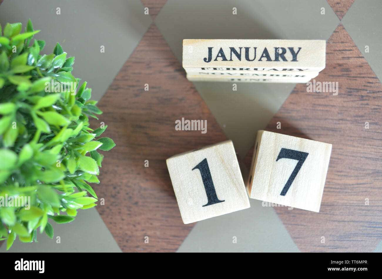 Date of February month with leaf on diamond pattern table for background. Stock Photo