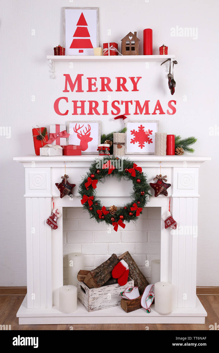 Fireplace With Christmas Decoration On Wooden Floor And White Wall