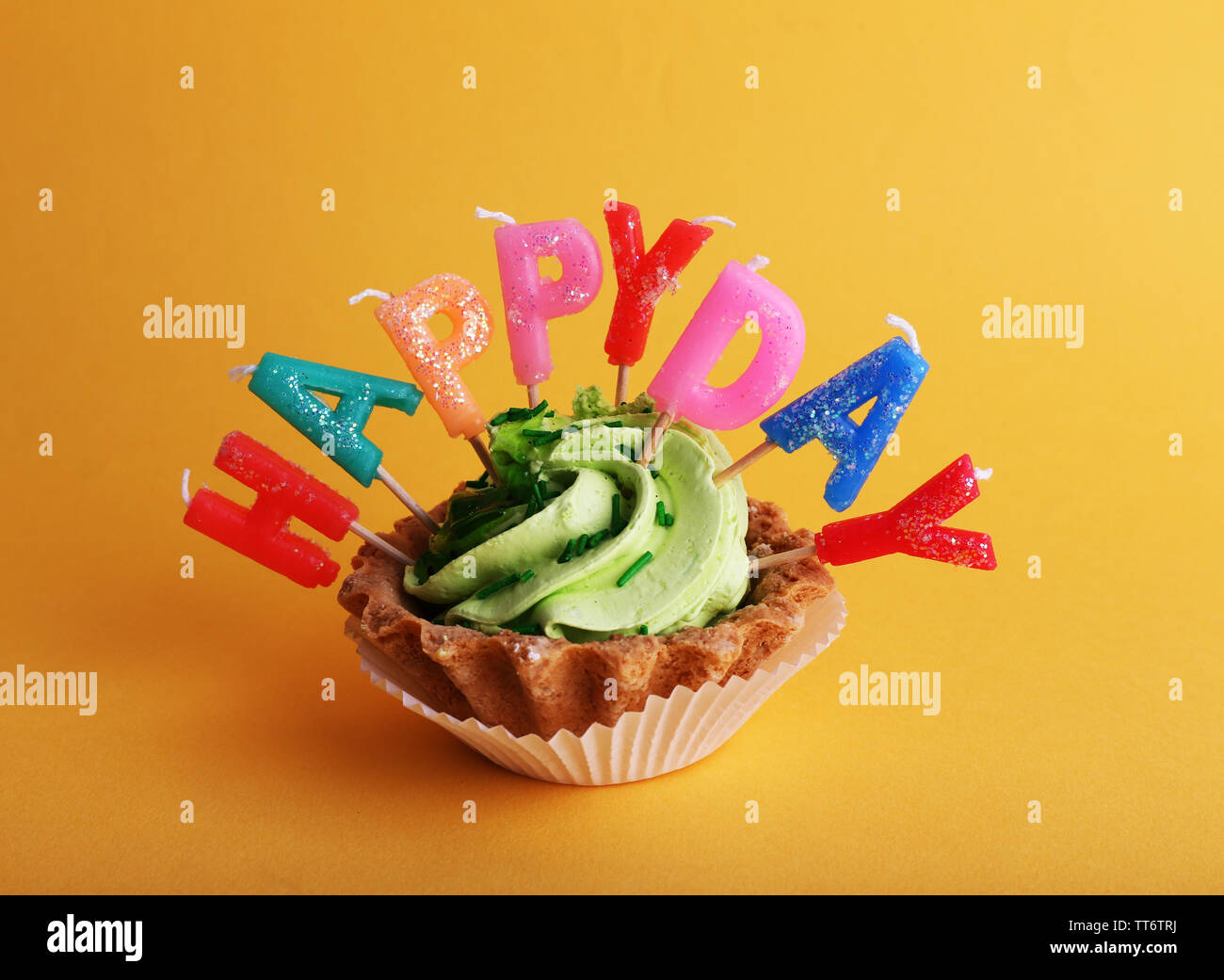 Cake with birthday candles on orange background Stock Photo - Alamy