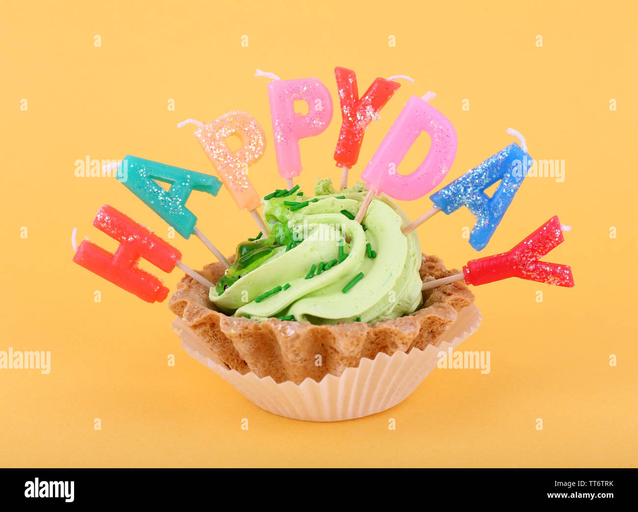 Cake with birthday candles on orange background Stock Photo - Alamy