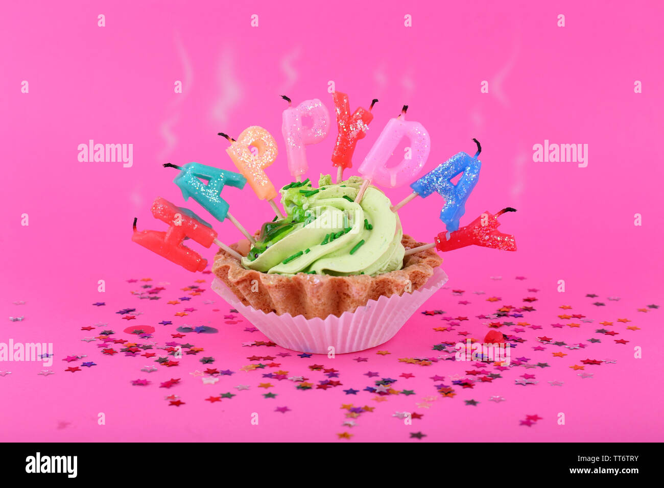 Cake with birthday candles on pink background Stock Photo - Alamy