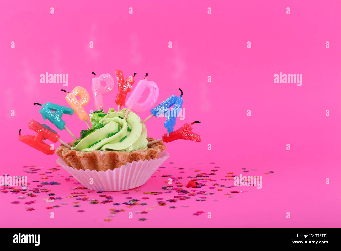 Cake with birthday candles on pink background Stock Photo - Alamy