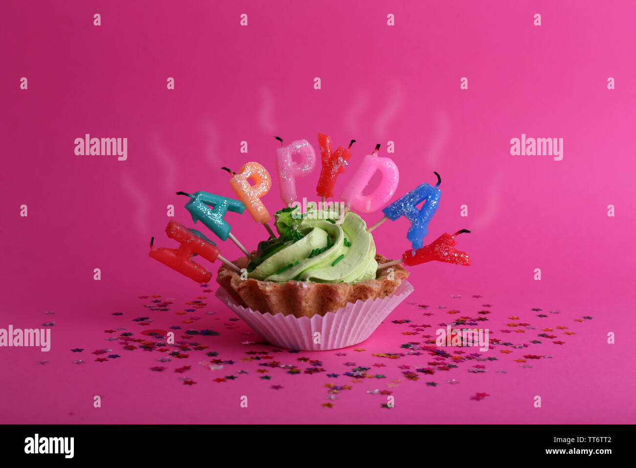 Cake with birthday candles on pink background Stock Photo - Alamy