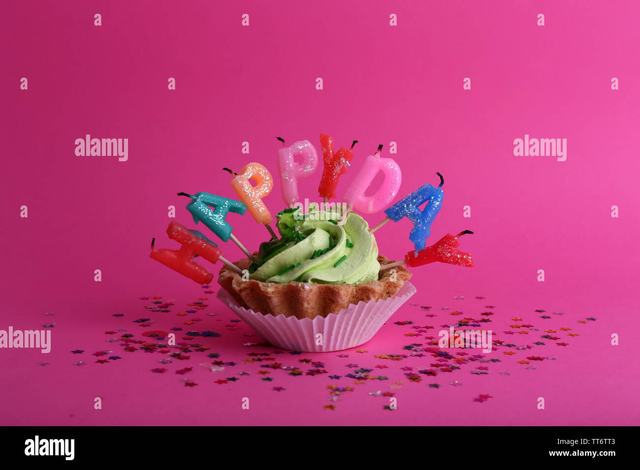 Cake with birthday candles on pink background Stock Photo - Alamy