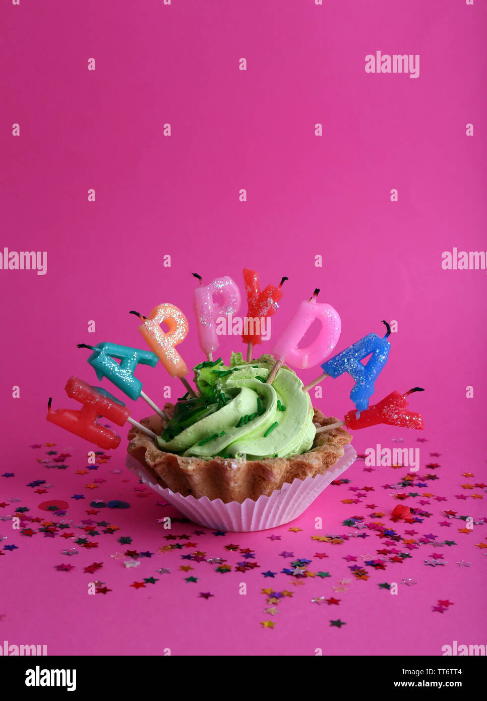 Cake with birthday candles on pink background Stock Photo - Alamy