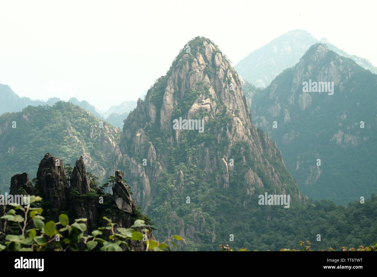 view of mountain tops and peaks of huangshan / yellow mountains in China after hiking up to the top and climbing millions of steps and stairs Stock Photo