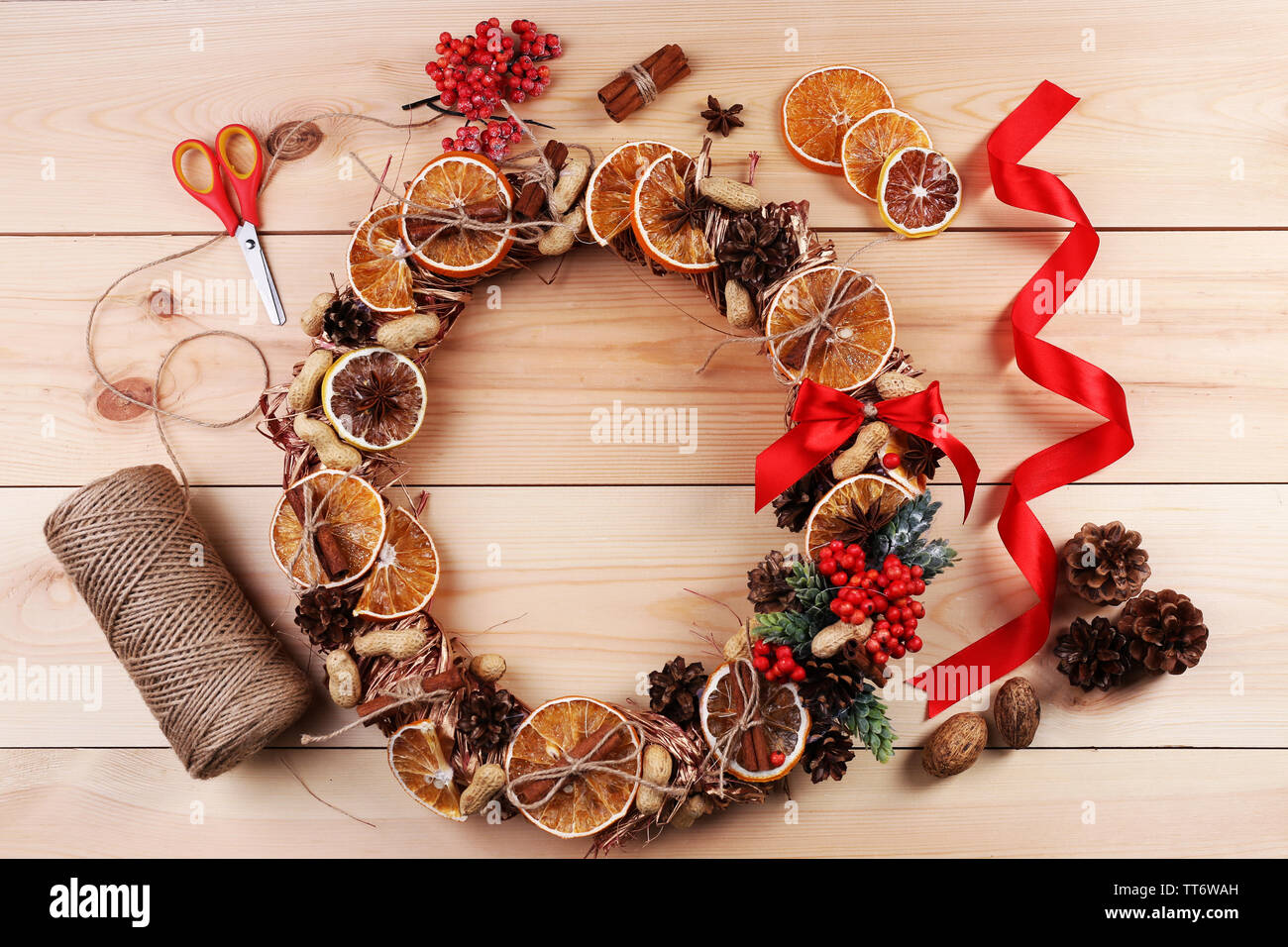 Christmas wreath with materials for decorating on wooden background Stock Photo