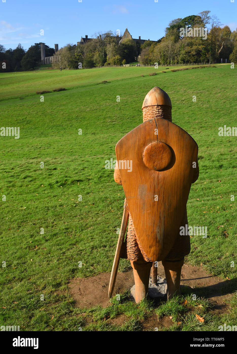 The Battle of Hasting  Battle site  with Battle Abbey in the background and full size carved  wooden soldier in foreground. Stock Photo
