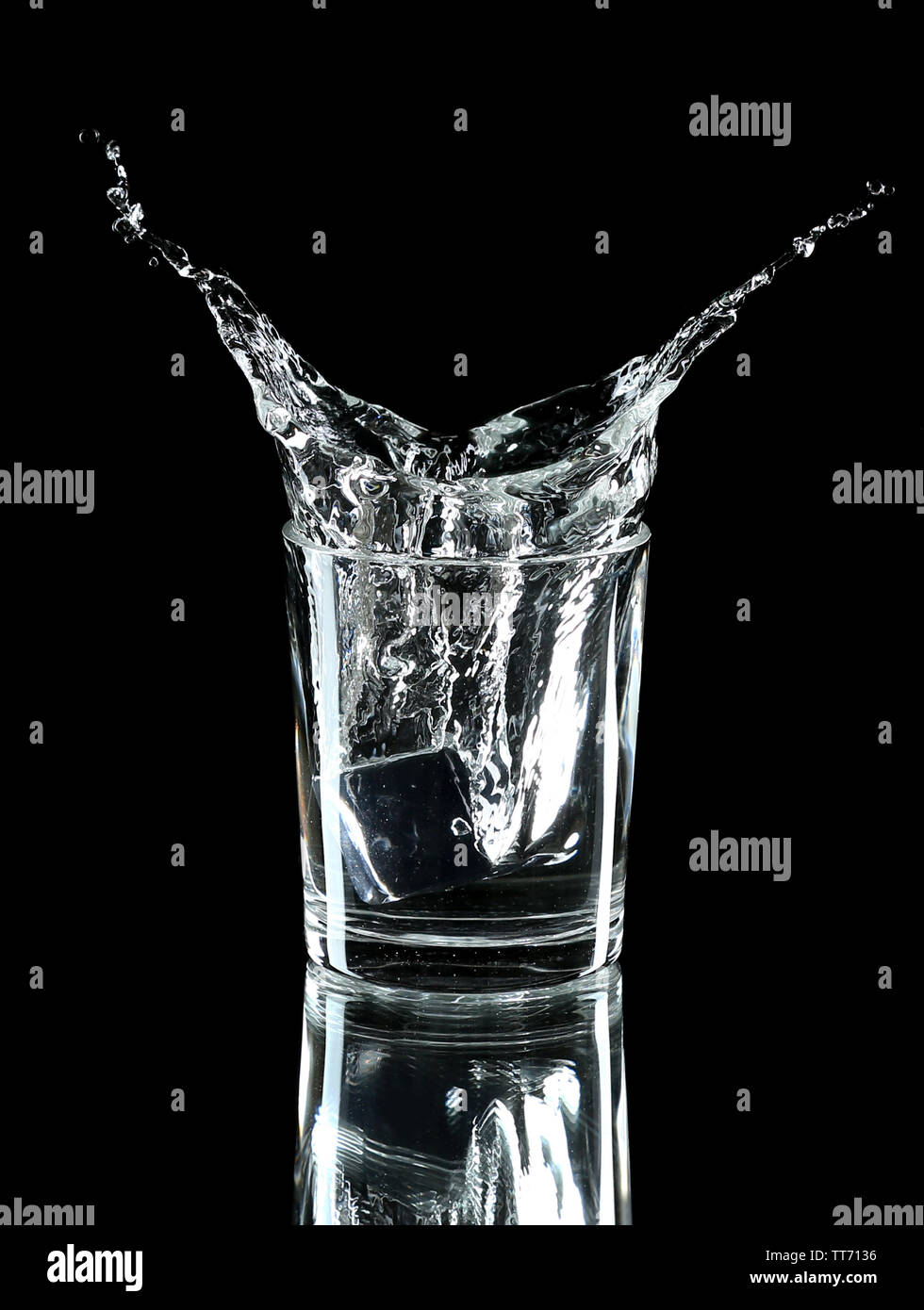 Water splash with ice in glass isolated on black Stock Photo - Alamy