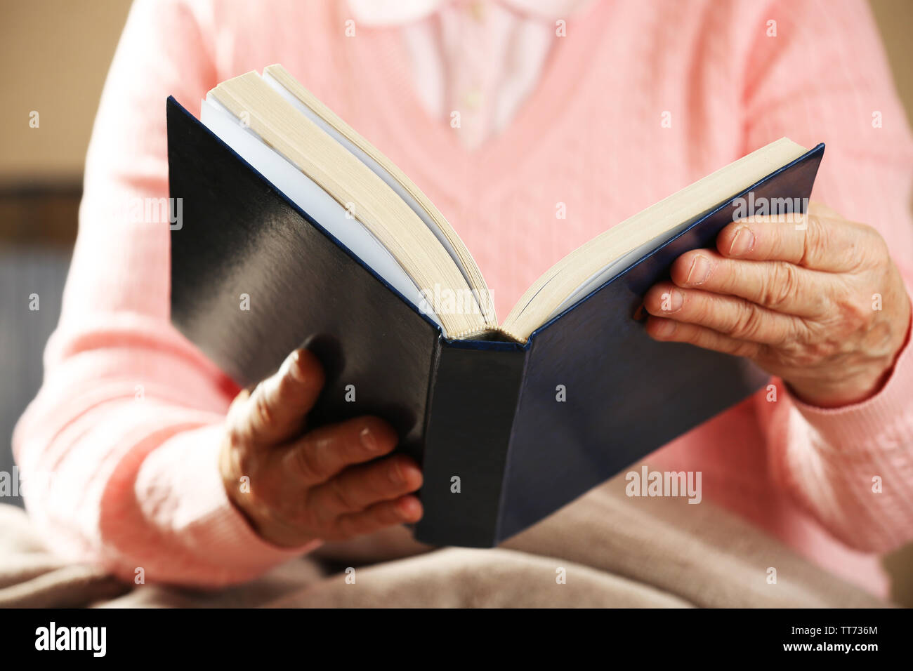 Old woman reading Bible, closeup Stock Photo