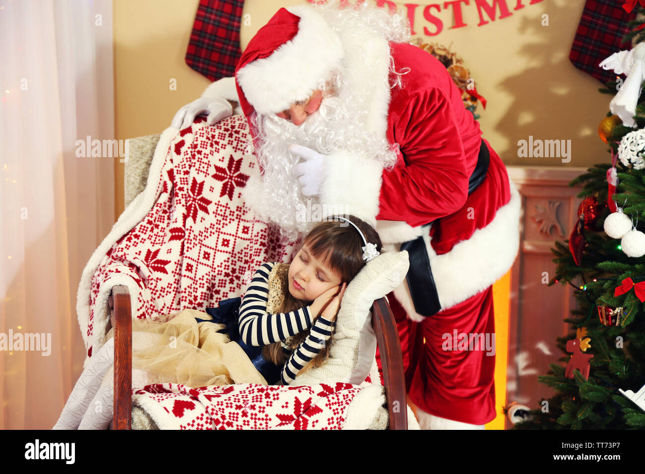 Santa Claus giving present to sleeping little cute girl Christmas tree ...