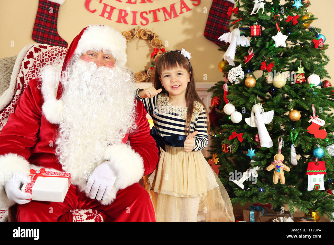 Santa Claus giving present to sleeping little cute girl Christmas tree ...