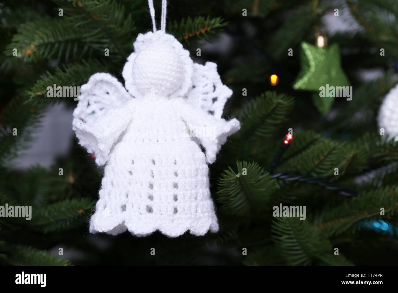 Knitted Christmas angels and other decorations on Christmas tree ...