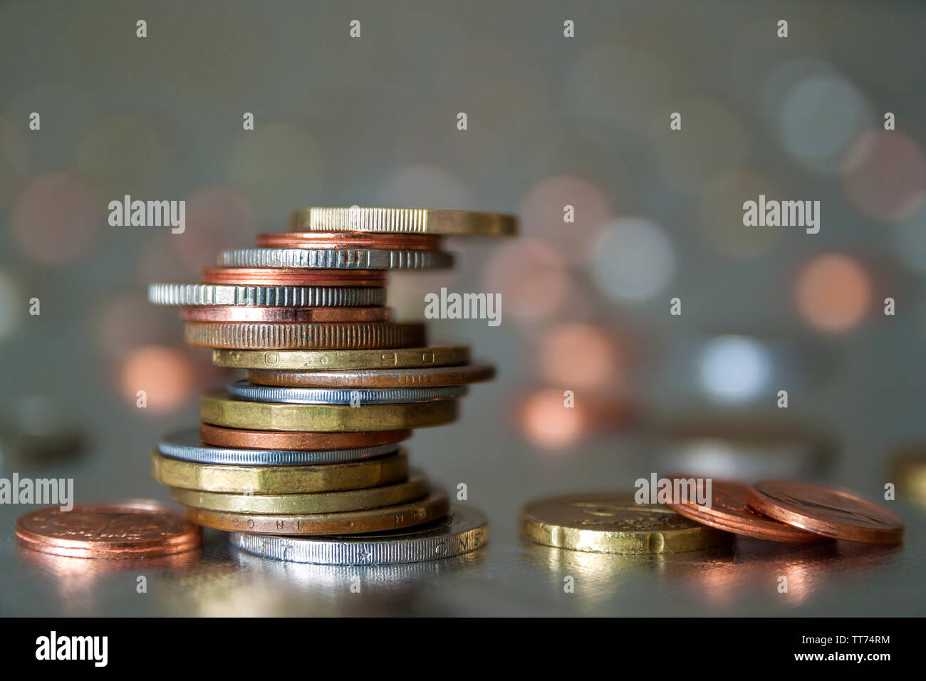 Shiny Coin Stack Pile of shiny coins different sizes and colors stacked unevenly on each ...
