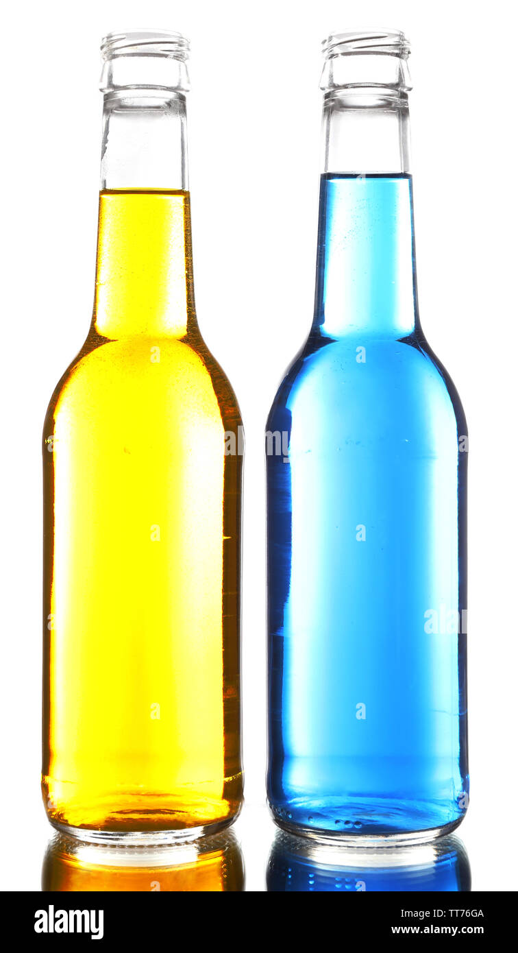 Colorful alcoholic beverages in glass bottles isolated on white Stock