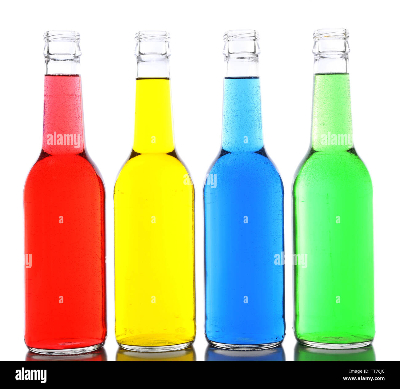 Colorful alcoholic beverages in glass bottles isolated on white Stock