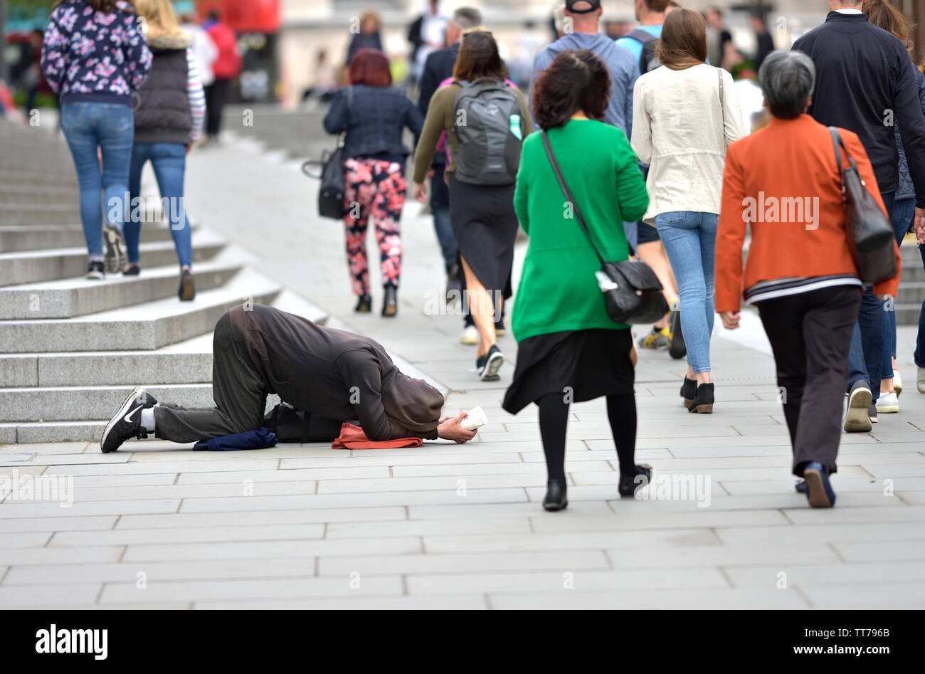 London, England, UK. Homeless man begging in Peters Hill, within sight of St Paul's Cathedral Stock Photo