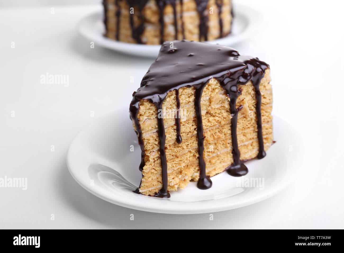 Chocolate cake on white table Stock Photo - Alamy