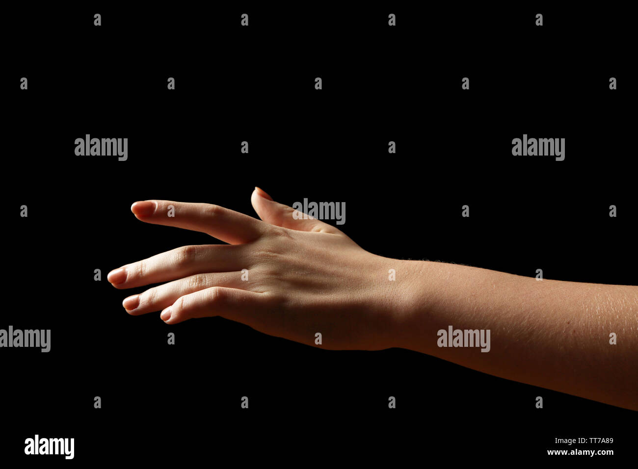 Female hand on dark background Stock Photo - Alamy