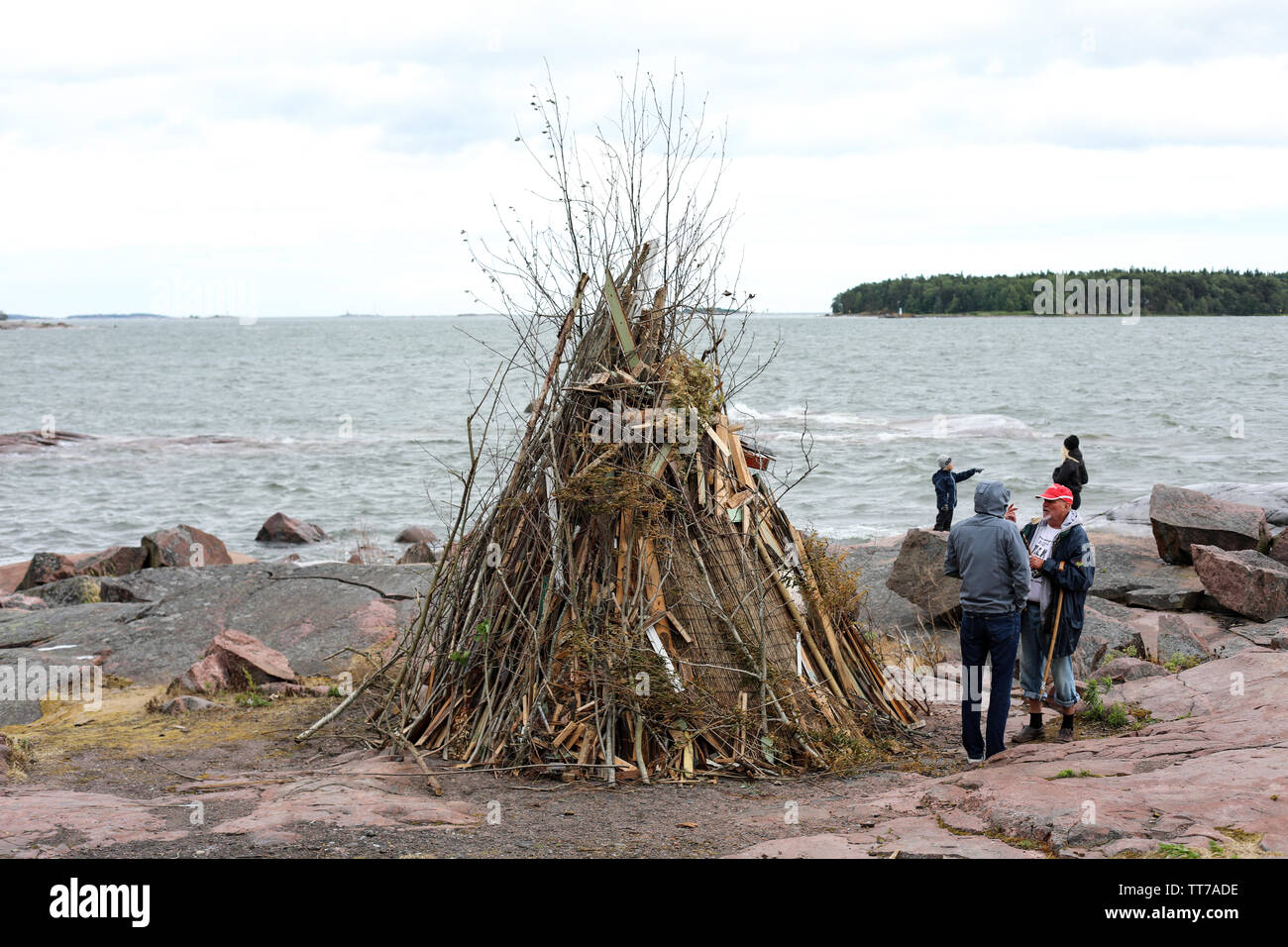 Traditional midsummer bonfire by the sea in Lauttasaari district, Helsinki Stock Photo